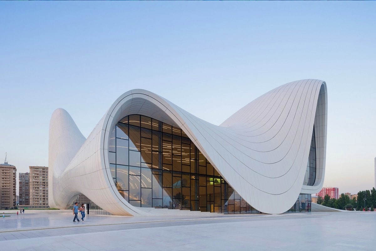 Classic Azerbaijan with Gabala Modern white curved architecture building with flowing wave-like design and large glass entrance, urban plaza with visitors