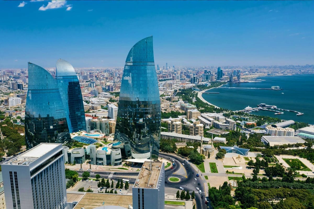Aerial view of Baku's Flame Towers overlooking the Caspian Sea coastline and city skyline in Azerbaijan