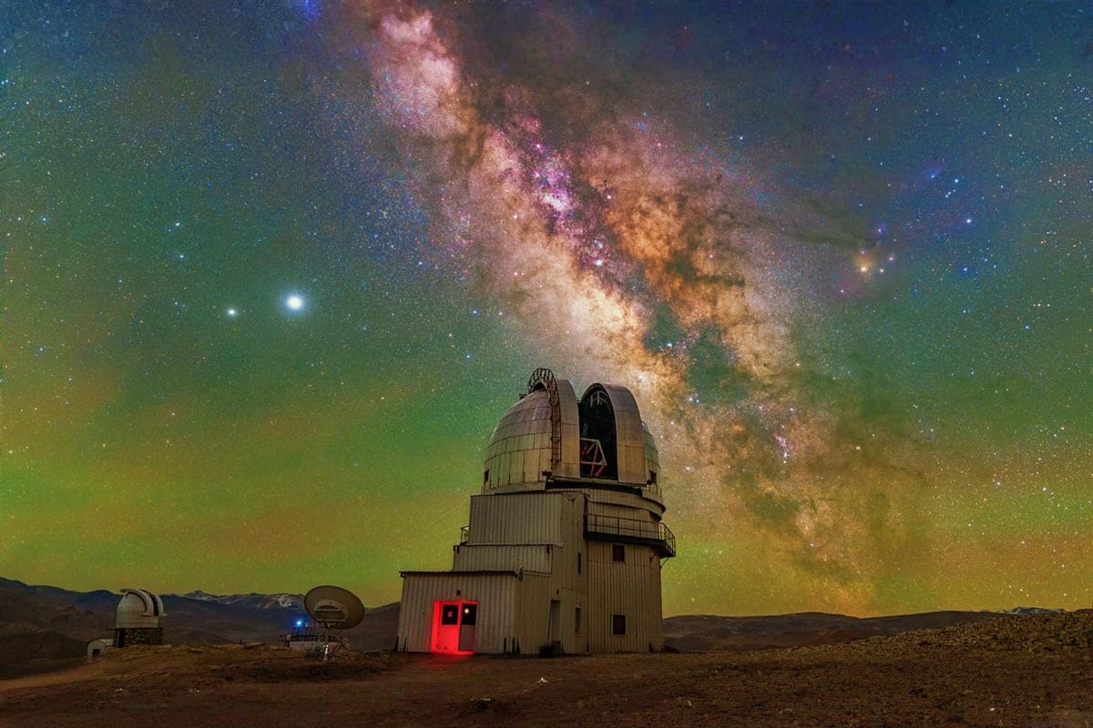 Observatory telescope dome with Milky Way galaxy visible in night sky above desert landscape in Ladakh, India