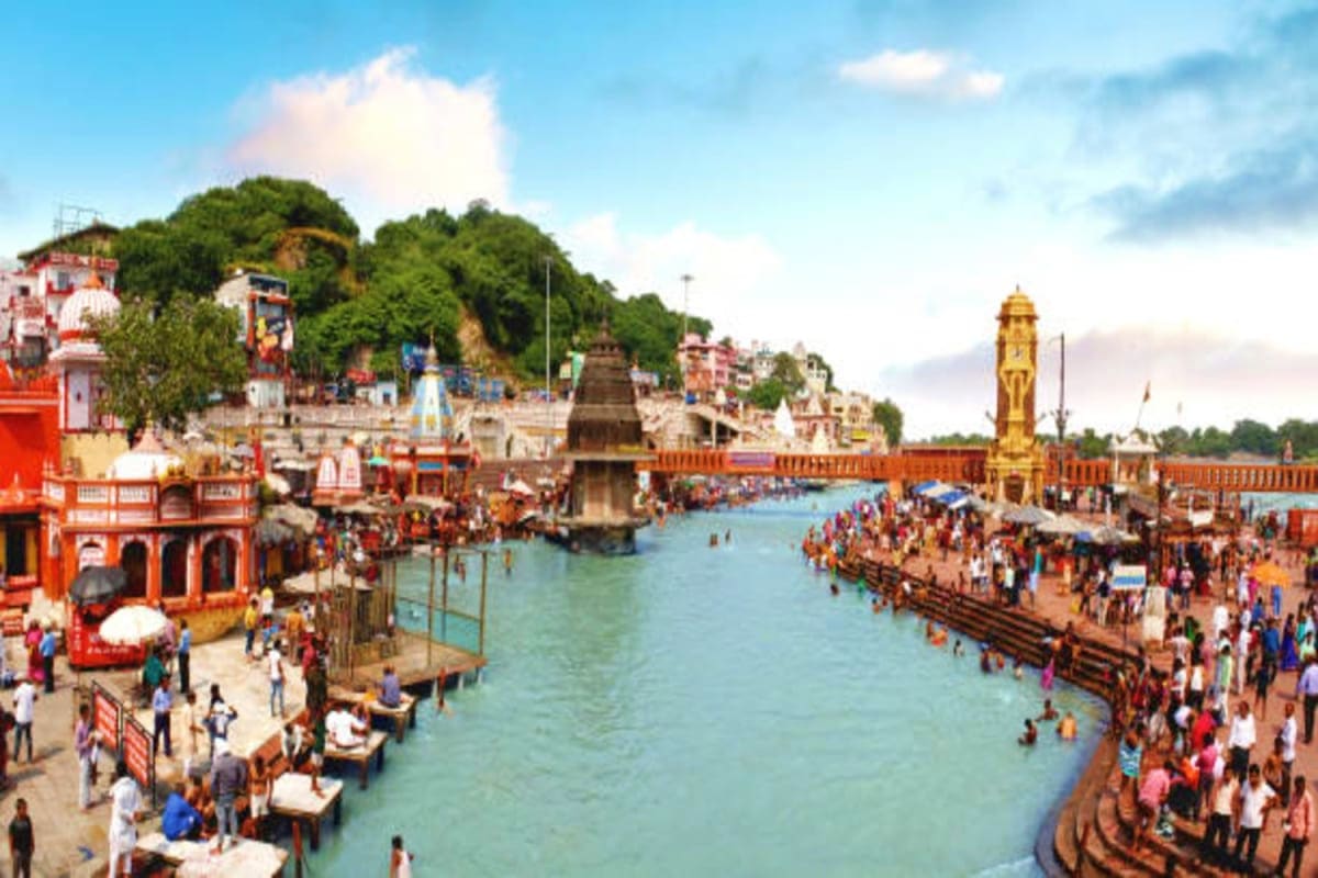 Har ki Pauri ghat in Haridwar with turquoise river, colorful temples, and crowds of pilgrims bathing and performing rituals a
