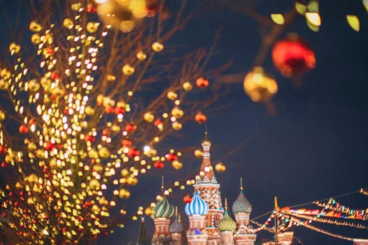 Illuminated ornaments and holiday lights frame Saint Basil's Cathedral at night in Moscow's Red Square