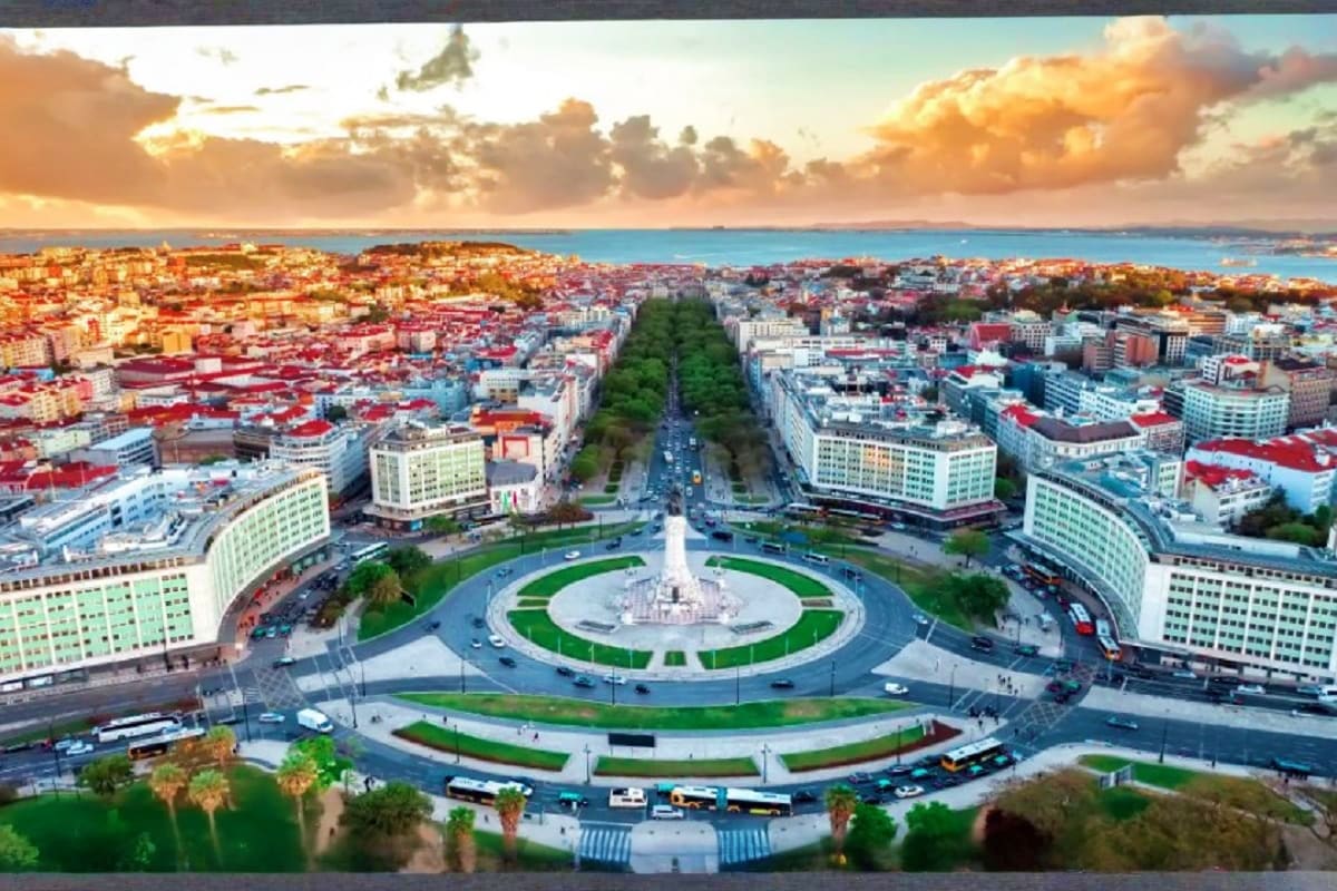 Aerial view of Taksim Square in Istanbul at sunset with central fountain, surrounding buildings, tree-lined avenue, and Sea o
