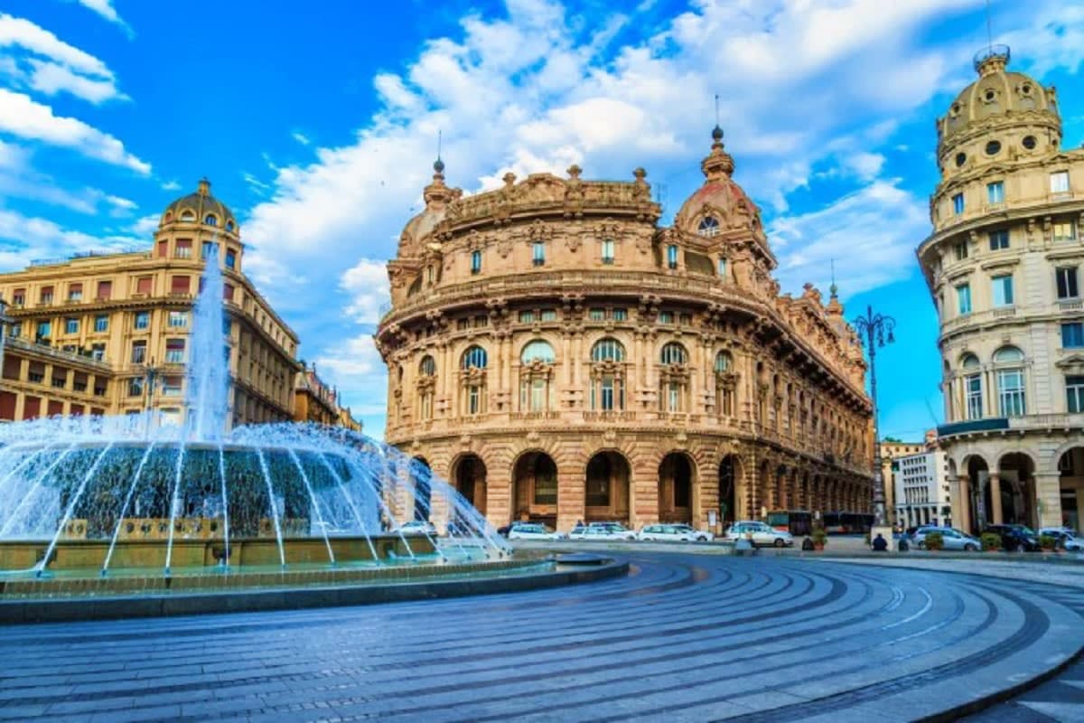Historic Palazzo building with ornate architecture and fountain in Genoa's De Ferrari Square, Italy