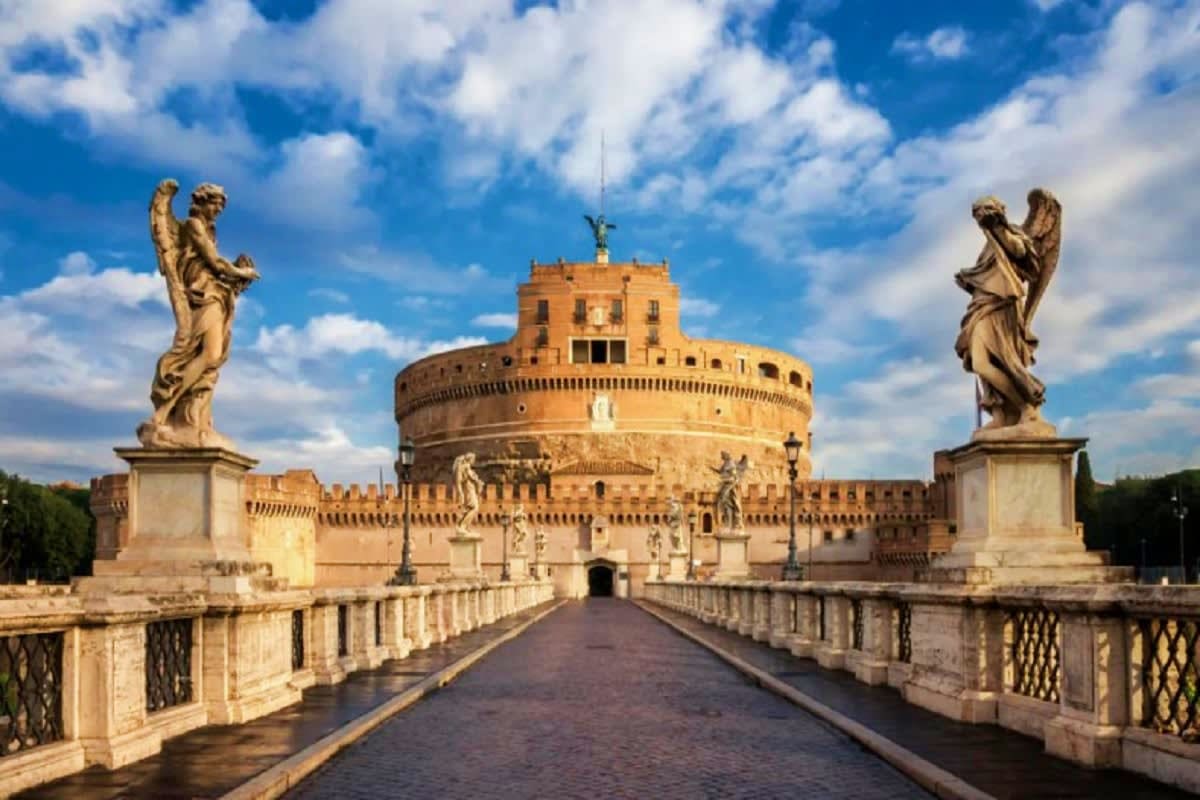 The Essential of Italy Castel Sant'Angelo in Rome with its iconic cylindrical fortress, angel statues on the bridge, and surrounding walls under a b