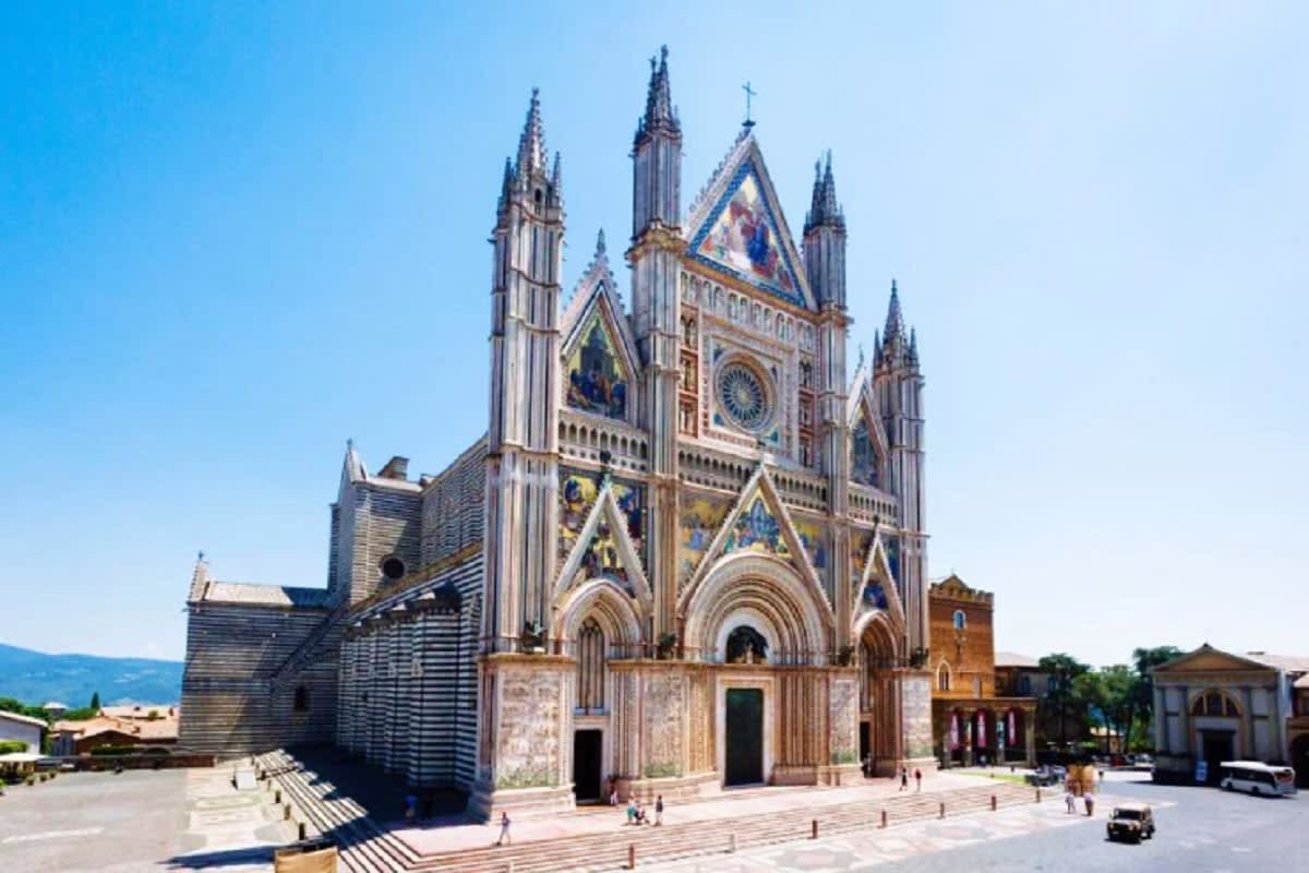 The Essential of Italy Orvieto Cathedral, a stunning Gothic church with pointed spires, ornate marble facade, and intricate rose window in Umbria, I