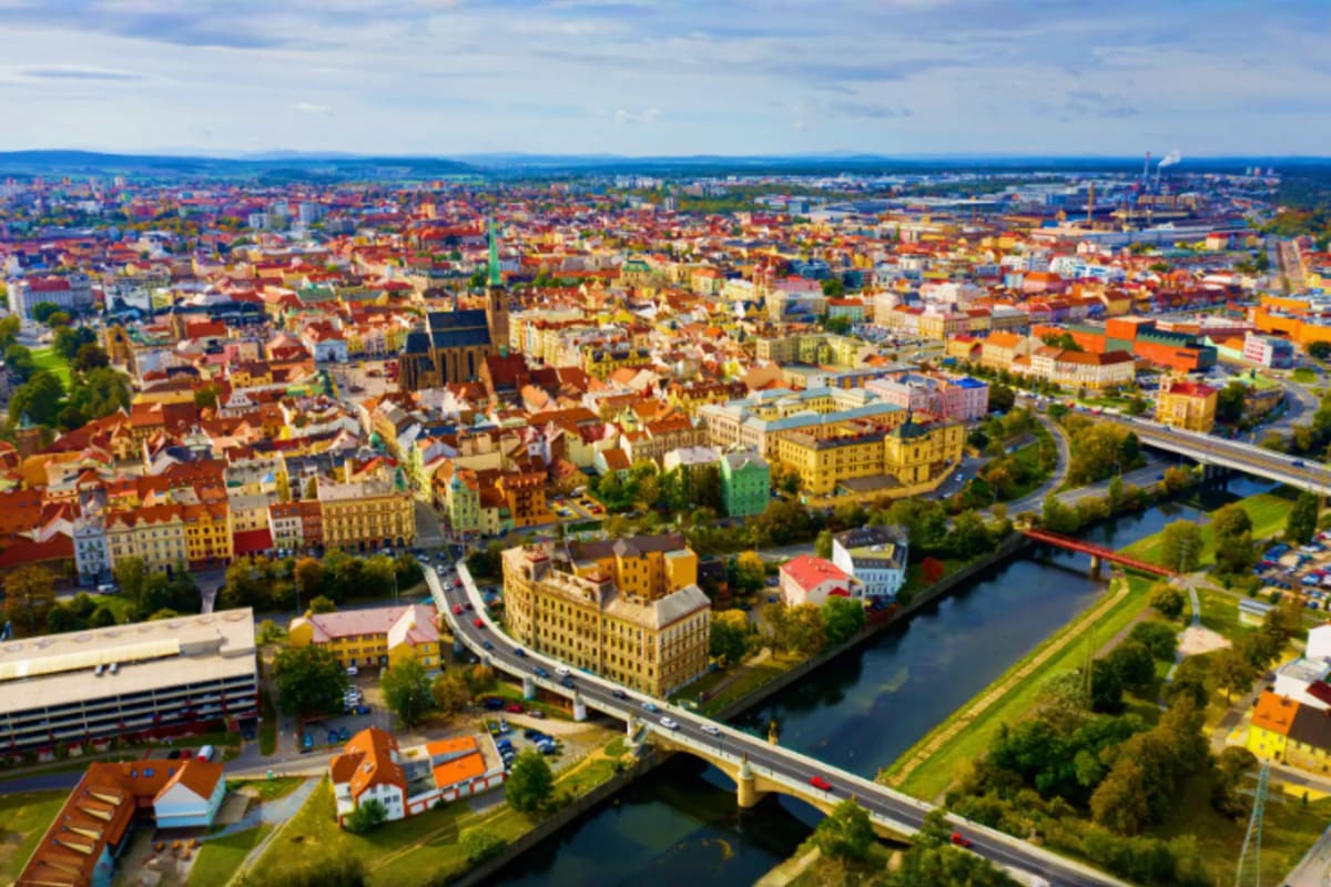 Aerial view of Olomouc city with colorful historic buildings, church spires, and Morava River with bridge in Czech Republic