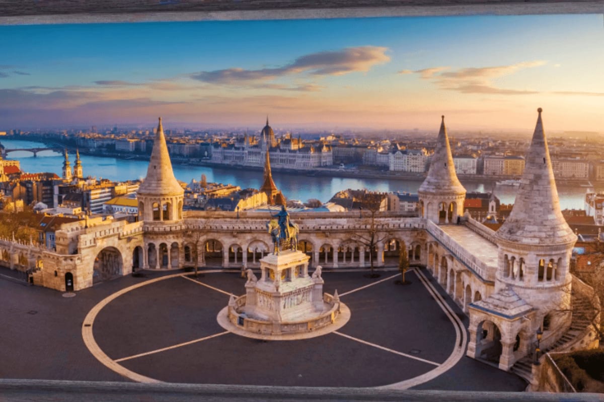 Fisherman's Bastion terrace at sunset overlooking the Danube River and Budapest skyline with Parliament Building in the dista
