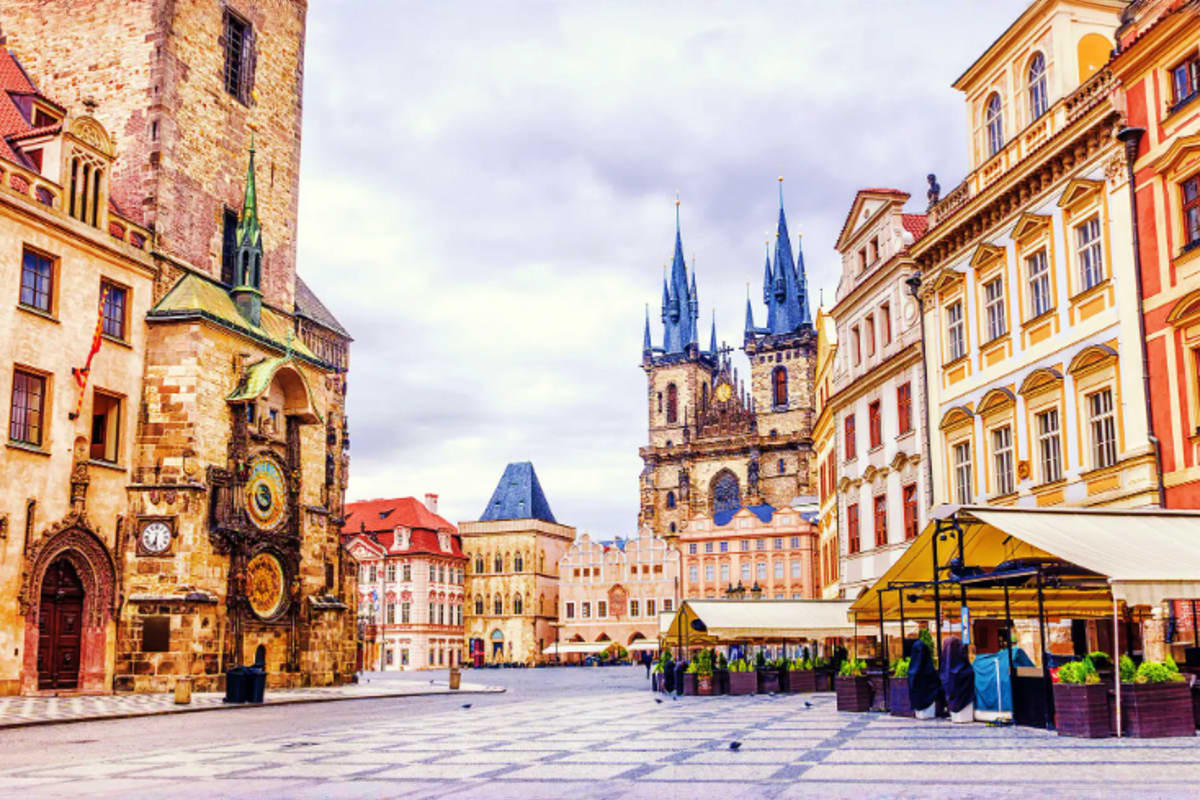 Historic Old Town Square in Prague with Church of Our Lady before Tyn, colorful buildings, and market stalls