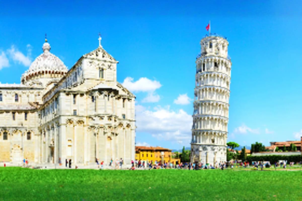 Leaning Tower of Pisa and Cathedral in Pisa's Piazza dei Miracoli with tourists on green lawn