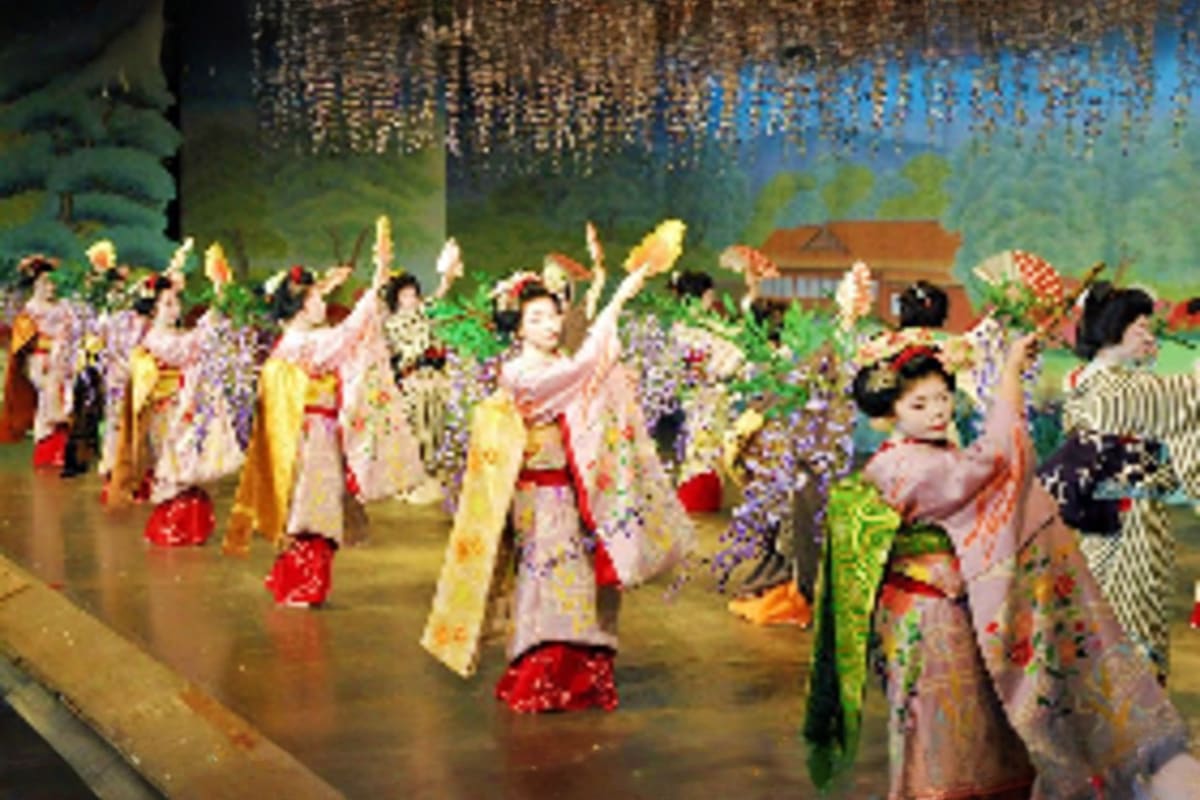 Essential Japan Tour Traditional Japanese festival celebration with women in colorful kimono and traditional dress dancing outdoors at night with