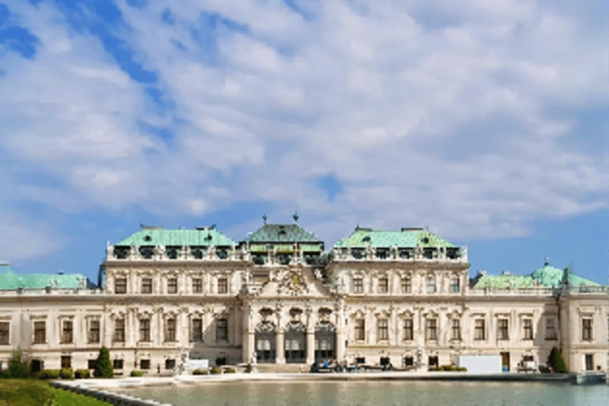 Glimpse of Europe Belvedere Palace in Vienna with ornate Baroque architecture, copper green roofs, and reflecting pond under cloudy sky