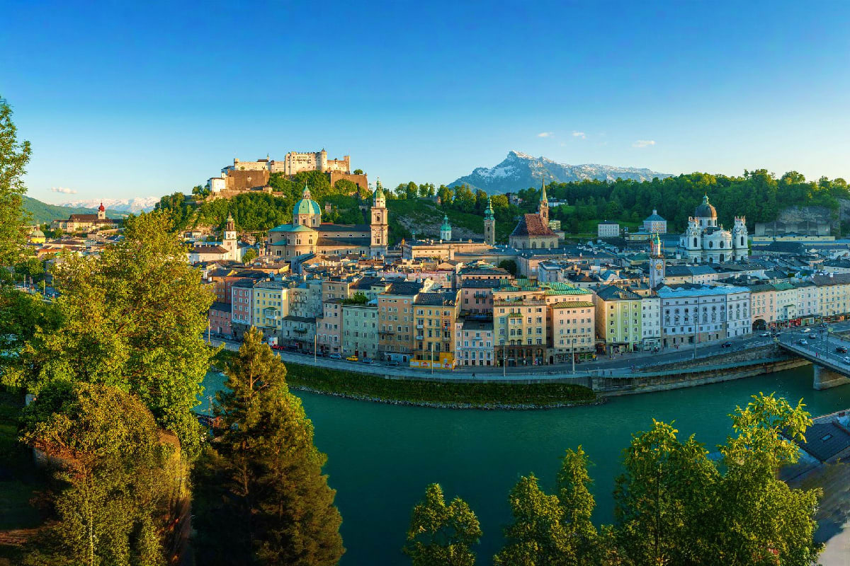 Best of Italy and Eastern Europe Salzburg cityscape with Hohensalzburg Castle perched on hilltop, turquoise Salzach River, baroque churches with green spires,