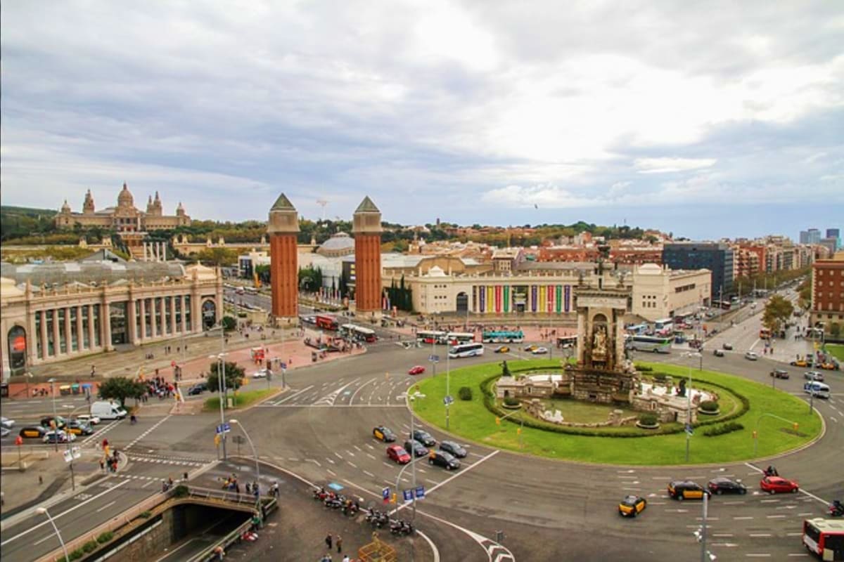 Aerial view of Plaça de Espanya in Barcelona with twin brick towers, National Art Museum, and Monument to Catalan Independenc