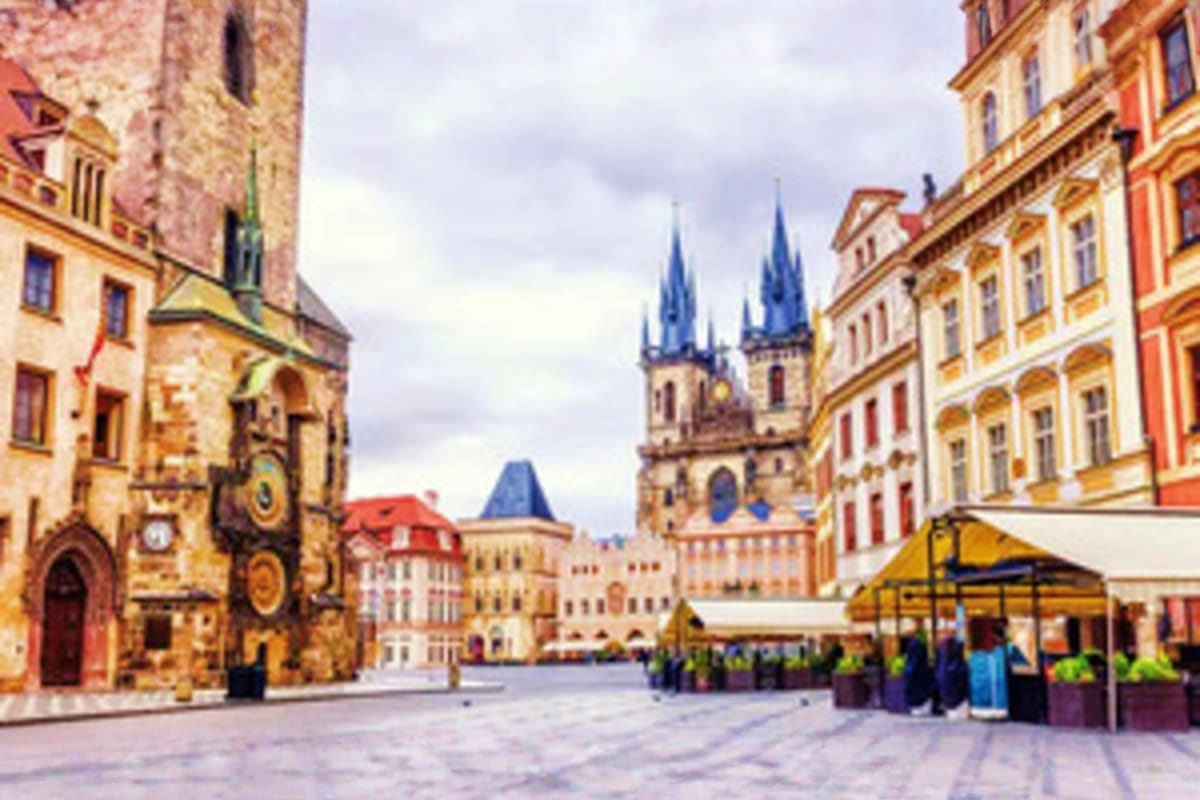 Old Town Square in Prague with Church of Our Lady before Tyn, colorful historic buildings, and outdoor café seating