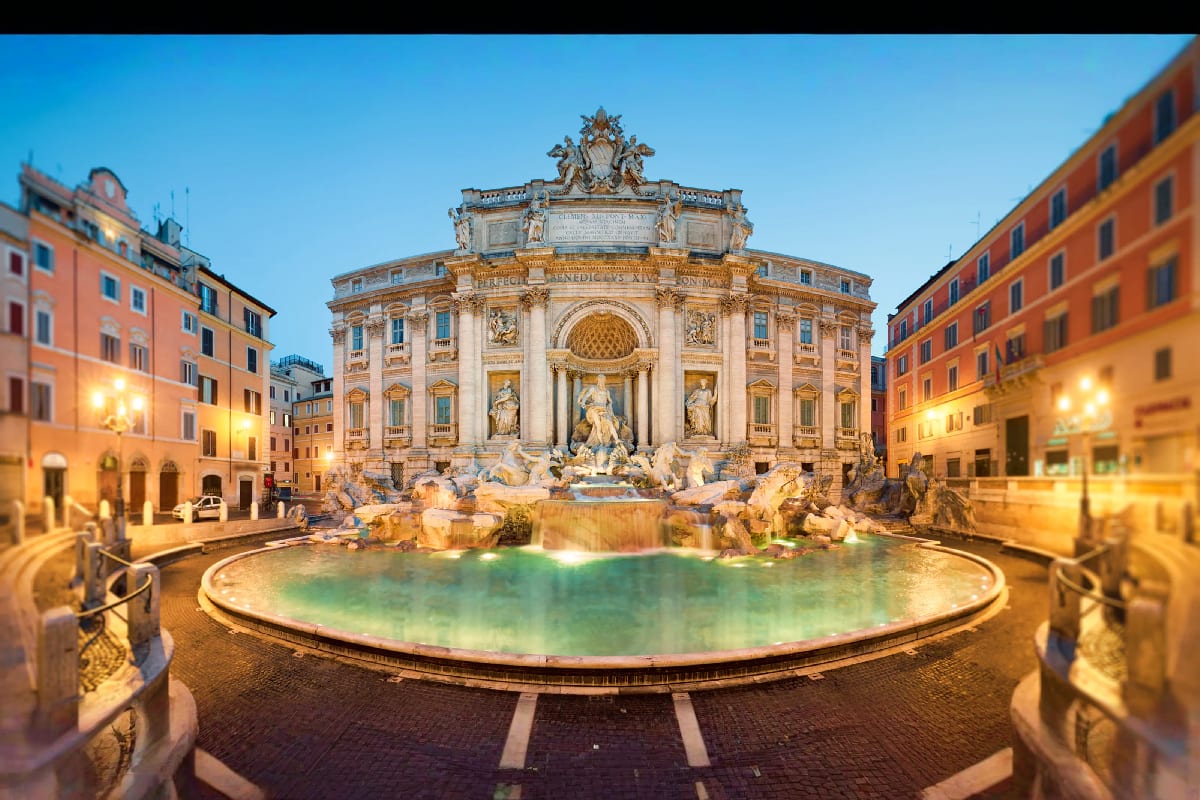 Italy Austria Budapest Journey Trevi Fountain illuminated at dusk in Rome, Italy, with baroque architecture and surrounding historic buildings