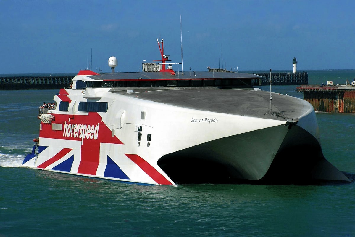 Seacat Rapide high-speed catamaran ferry with Union Jack livery docked at English harbor pier