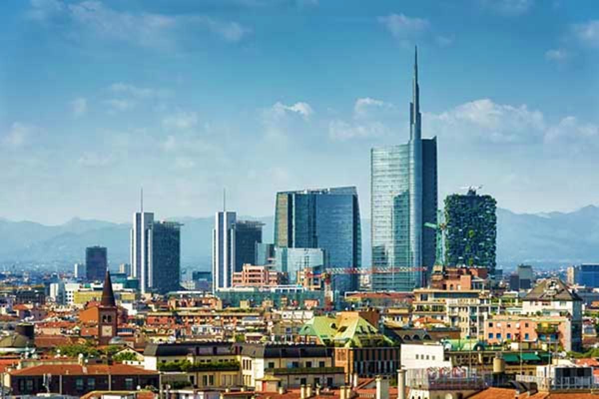 Frankfurt skyline with modern skyscrapers and historic buildings in foreground, mountains visible in background under clear b