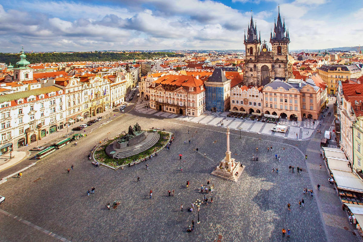 Aerial view of Prague's Old Town Square with twin spires of Church of Our Lady before Týn and historic colorful buildings
