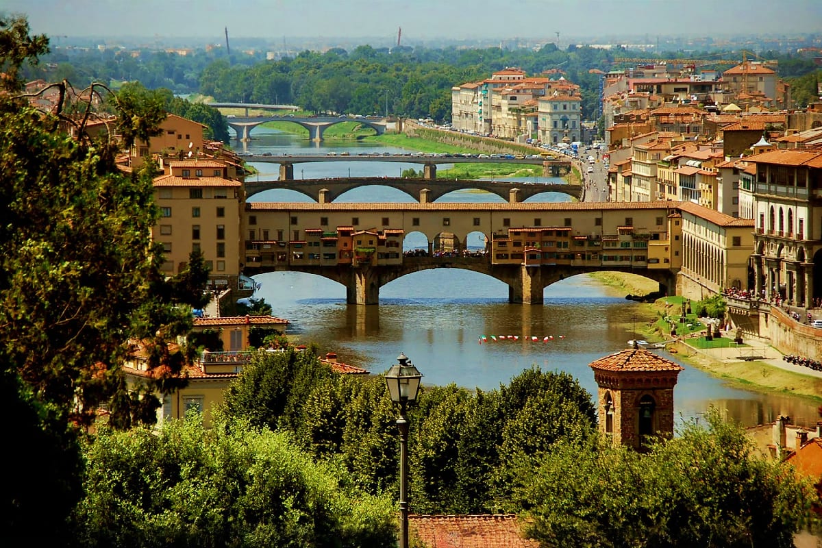 Ponte Vecchio medieval bridge spanning the Arno River in Florence, Italy, with historic buildings and multiple bridges visibl