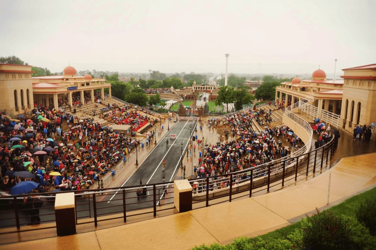 Aerial view of Red Fort complex in Amritsar with large crowds gathered in courtyards and ceremonial grounds during daytime