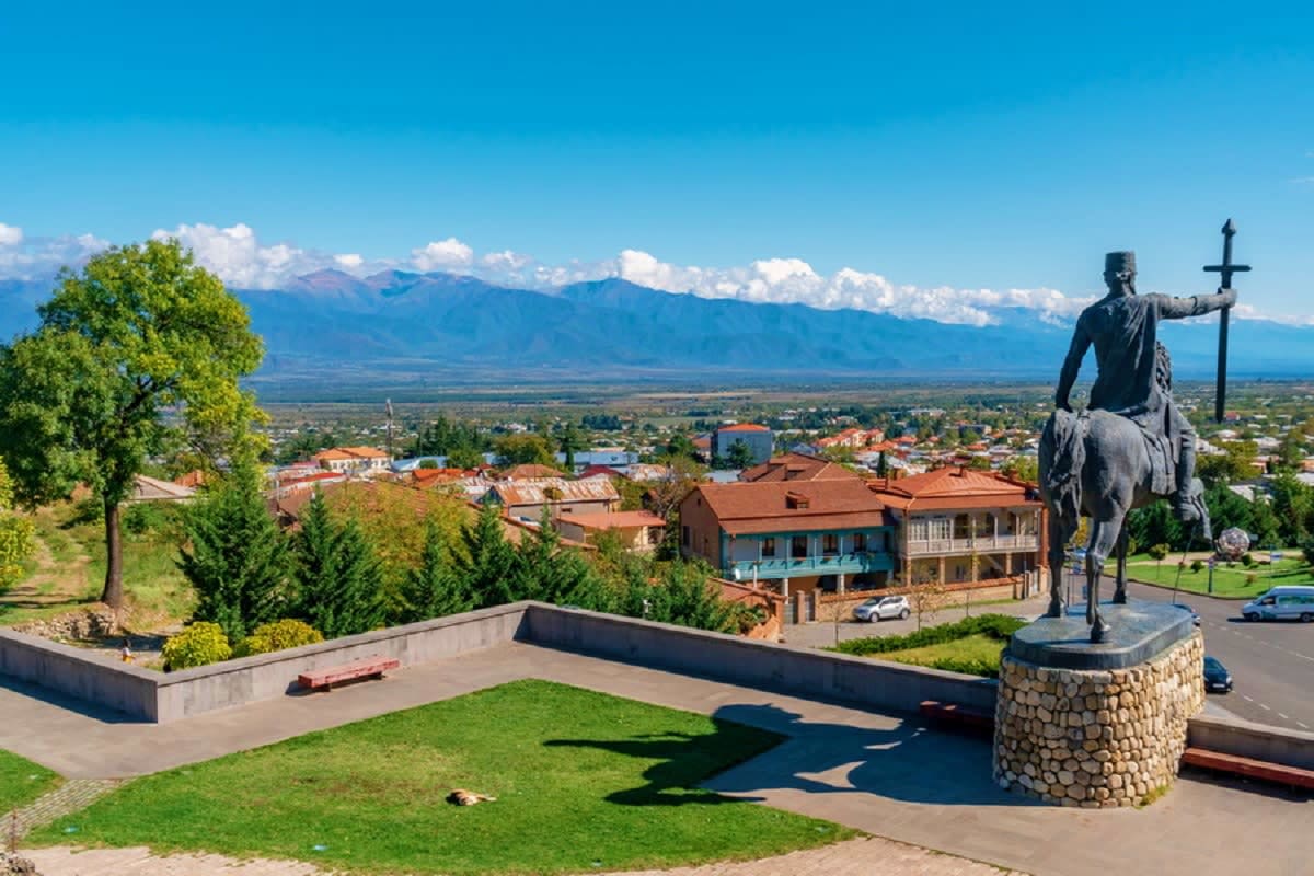 Equestrian statue overlooking Sighnaghi town with Caucasus Mountains and valley landscape in Georgia