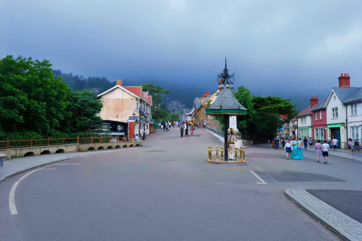 Pedestrian street in Shimla hill station with ornate gazebo, colorful colonial buildings, and tourists walking under cloudy m