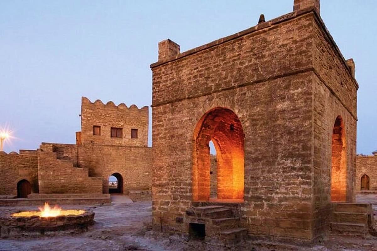 Ancient stone fortress with illuminated archway at dusk in Baku, Azerbaijan, showing traditional architecture and defensive s