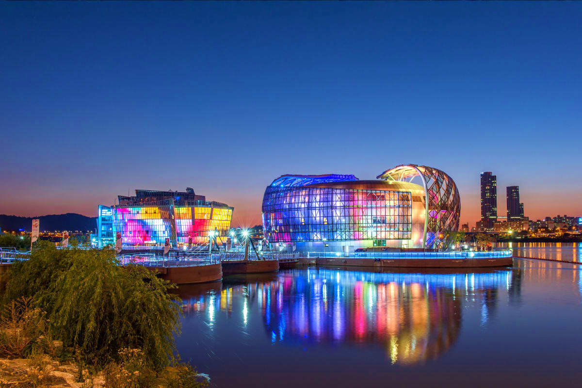Illuminated modern buildings reflected in water at twilight in Baku, Azerbaijan with city skyline