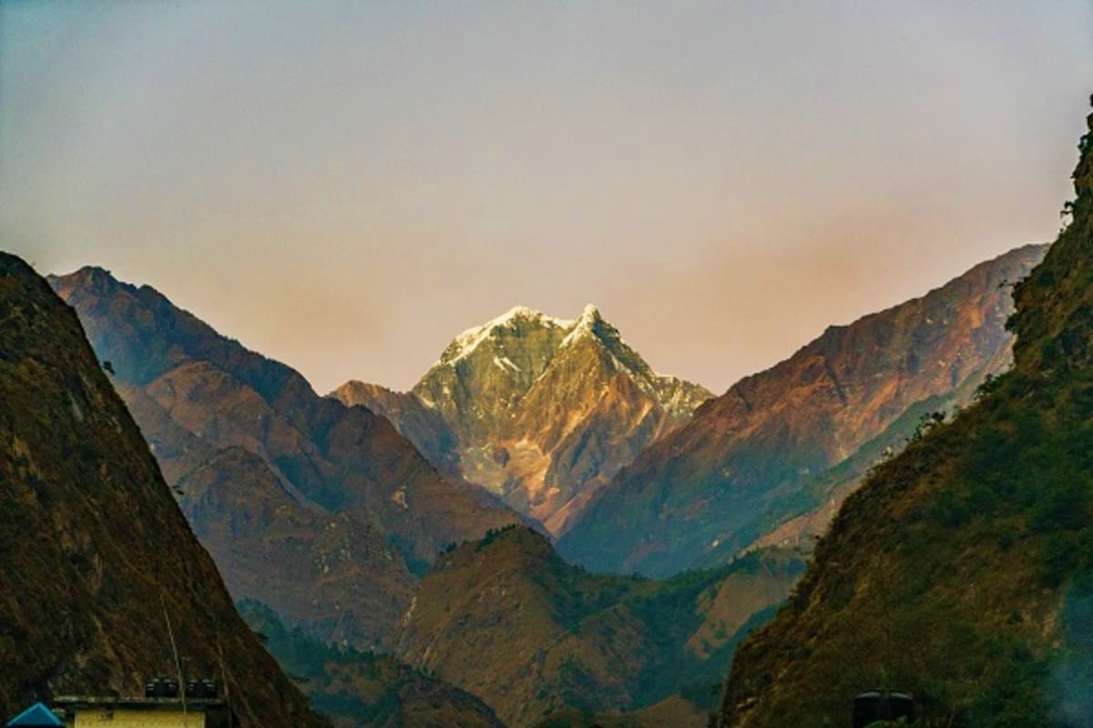 Snow-capped mountain peak framed by steep rocky valley walls in the Caucasus Mountains, Azerbaijan landscape