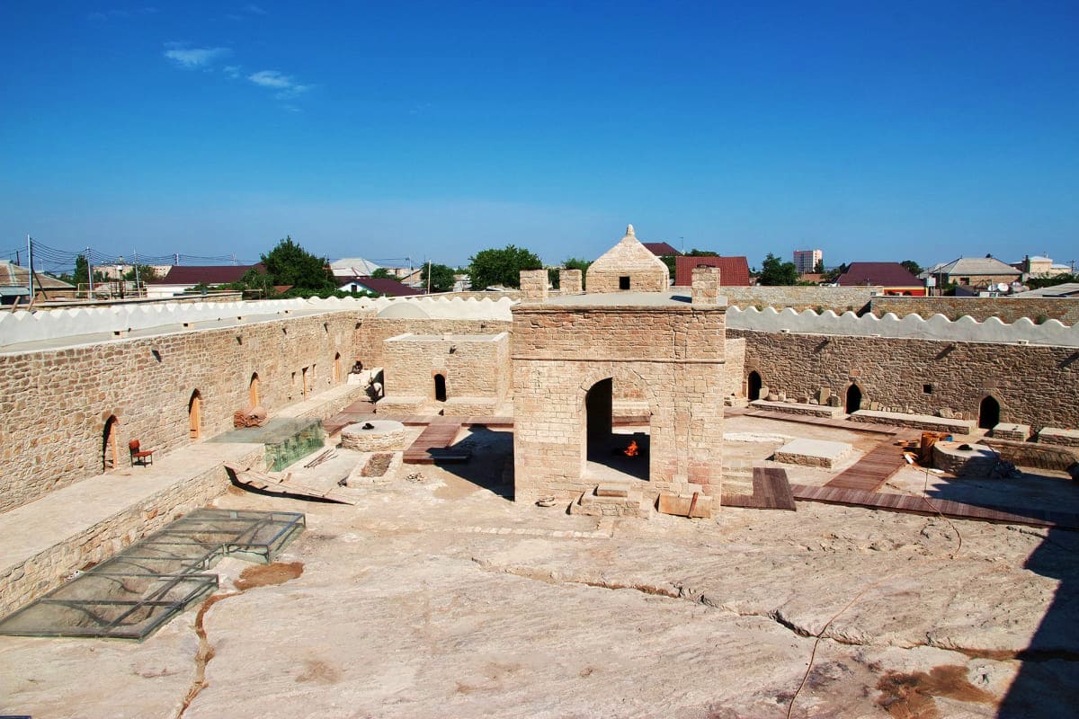 Interior courtyard of Icherisheher fortress with historic stone walls and arches in Baku, Azerbaijan