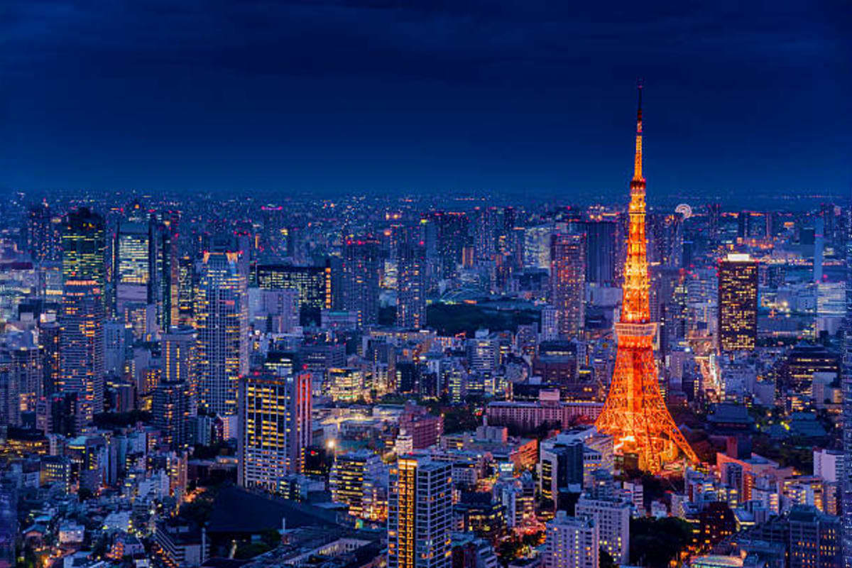 Central Japan Tokyo skyline at dusk with illuminated Tokyo Tower and surrounding cityscape buildings lit up at night