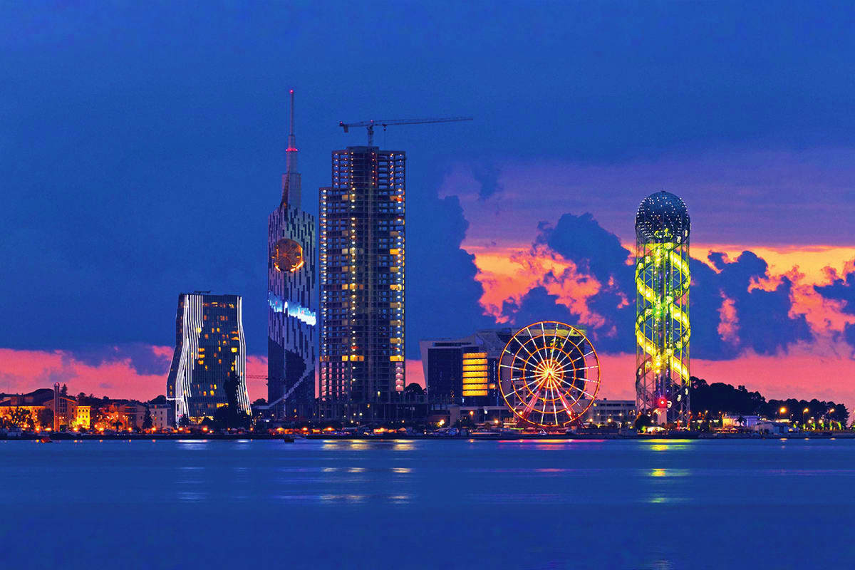 Dusseldorf skyline at twilight with illuminated Ferris wheel and modern architecture reflected in Rhine River