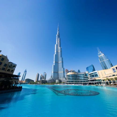 Burj Khalifa and Dubai skyline reflected in turquoise water of Burj Lake during daytime