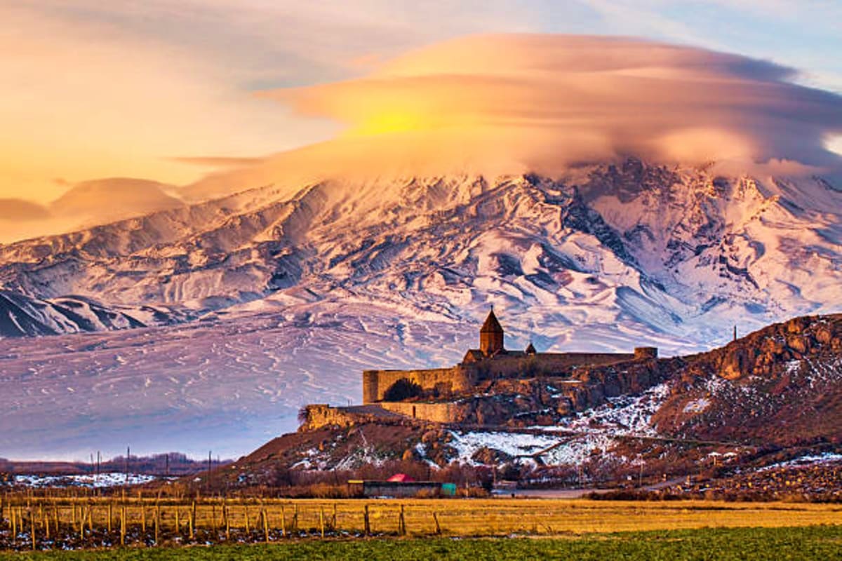 Khor Virap monastery with snow-capped Mount Ararat in background at sunset, Armenia