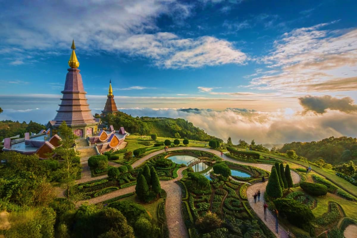 Thailand 4 City Island and Adventure Tour Doi Inthanon temple with golden stupas overlooking misty mountains and manicured gardens in Chiang Mai, Thailand
