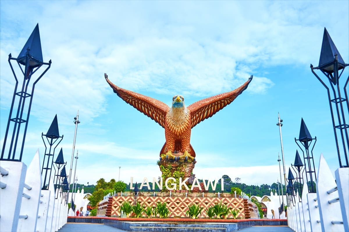 Golden eagle monument with wings spread at Langkawi entrance gate under blue sky