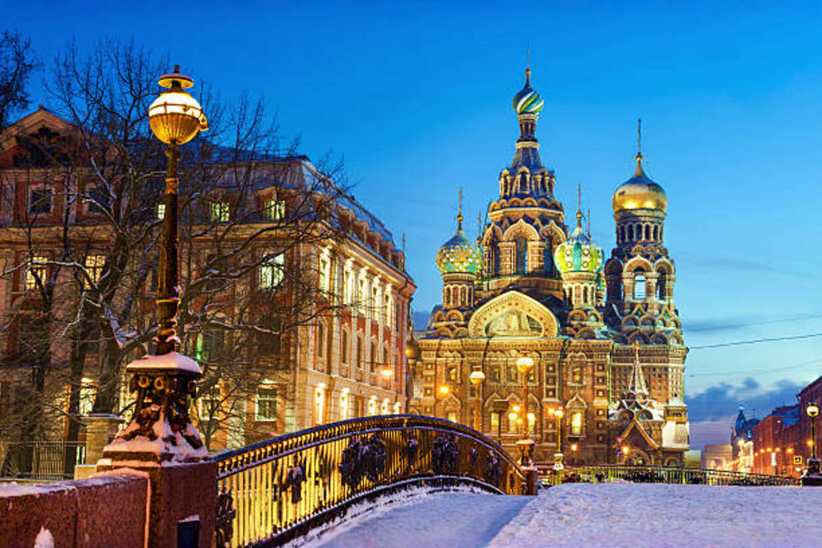 Church of the Savior on Spilled Blood in Saint Petersburg at twilight with snow-covered bridge and winter landscape