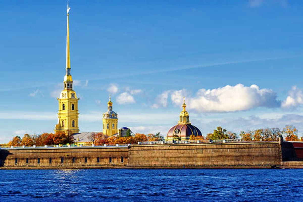 Peter and Paul Fortress with golden spires and cathedral dome on Neva River in Saint Petersburg, Russia