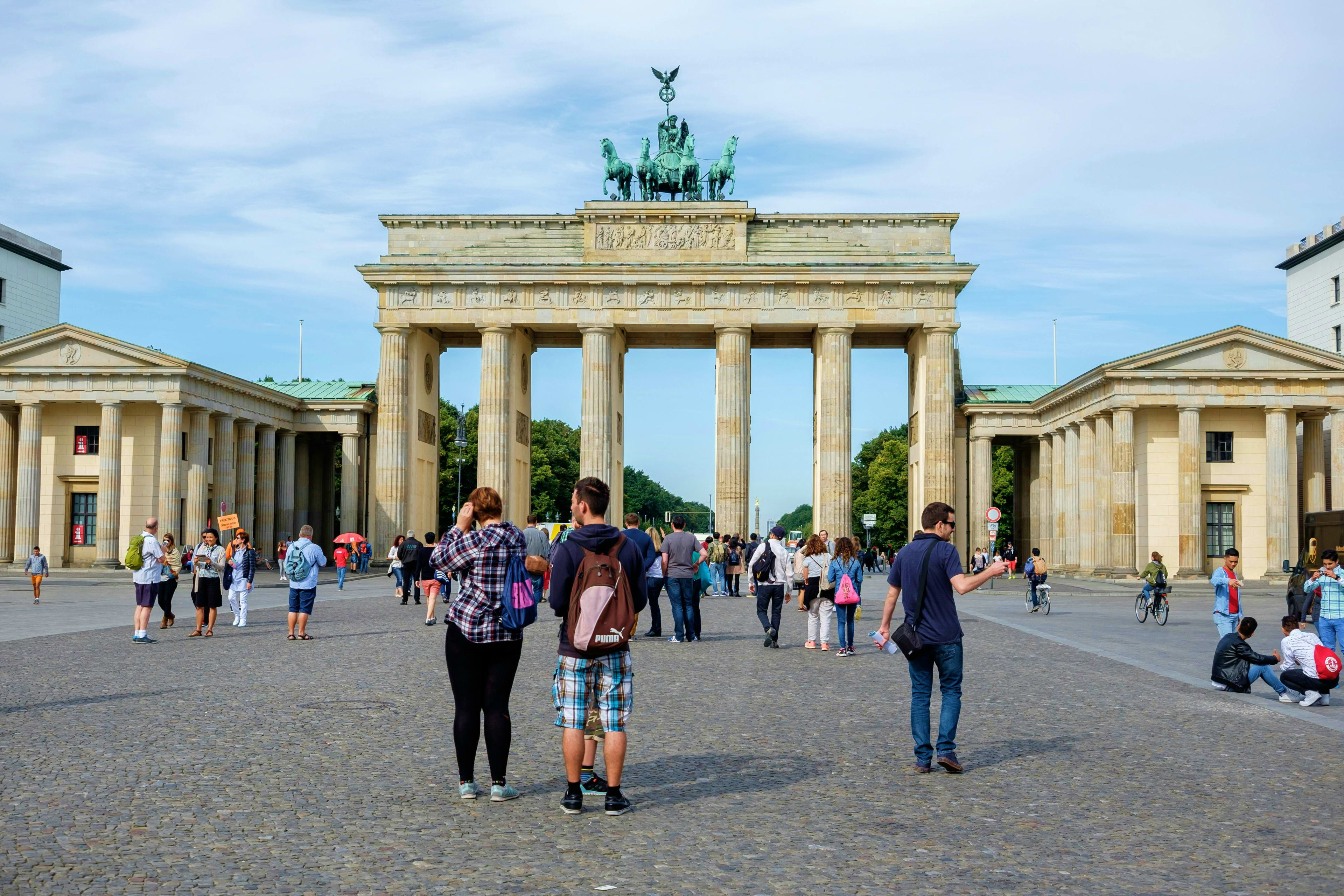 Germany Tourists gathering at Brandenburg Gate in Berlin, Germany with classical stone columns and chariot sculpture on top