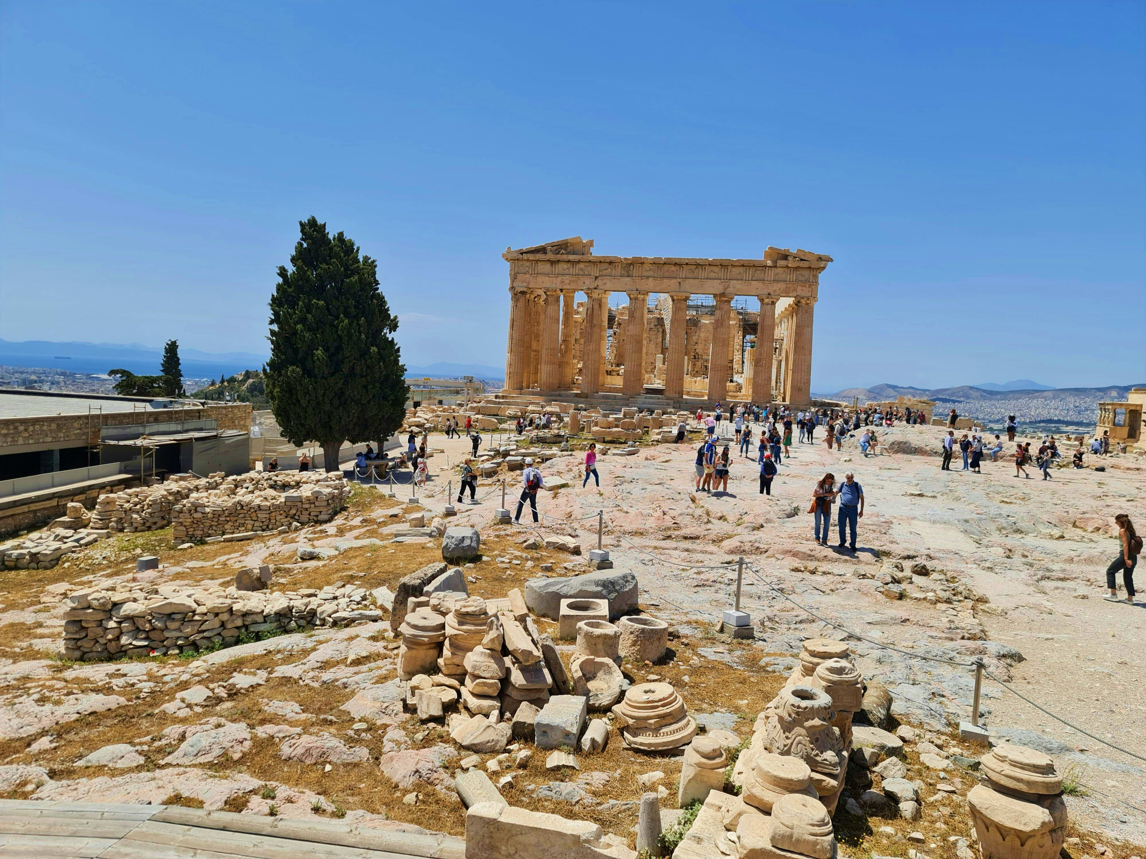 Greece Ancient Greek ruins of the Parthenon temple with tourists exploring the archaeological site in Athens