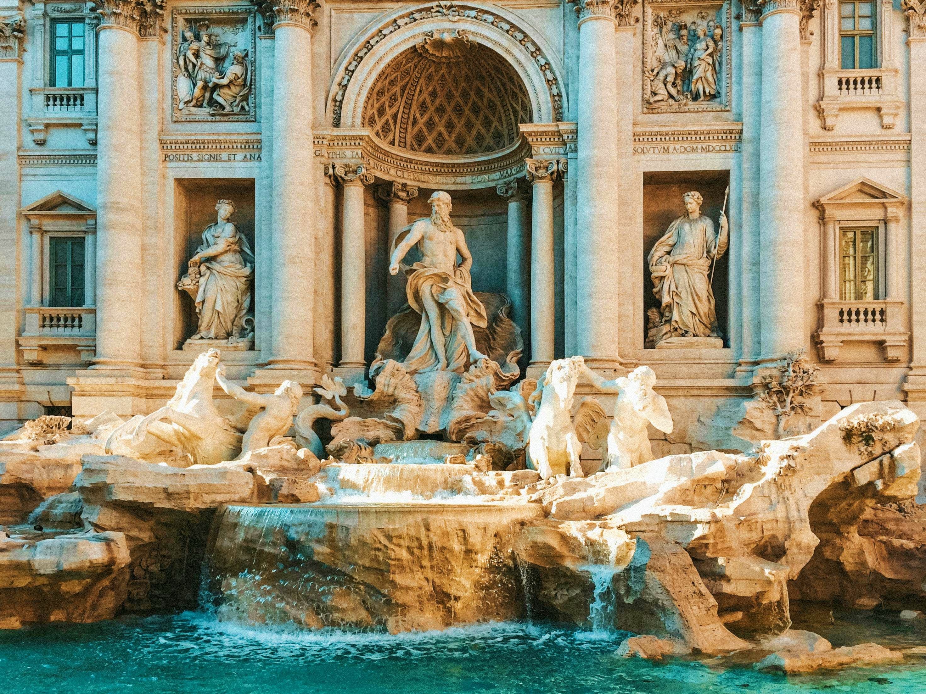 Italy Trevi Fountain in Rome with baroque sculptures and turquoise water, featuring central Neptune statue and classical architectu