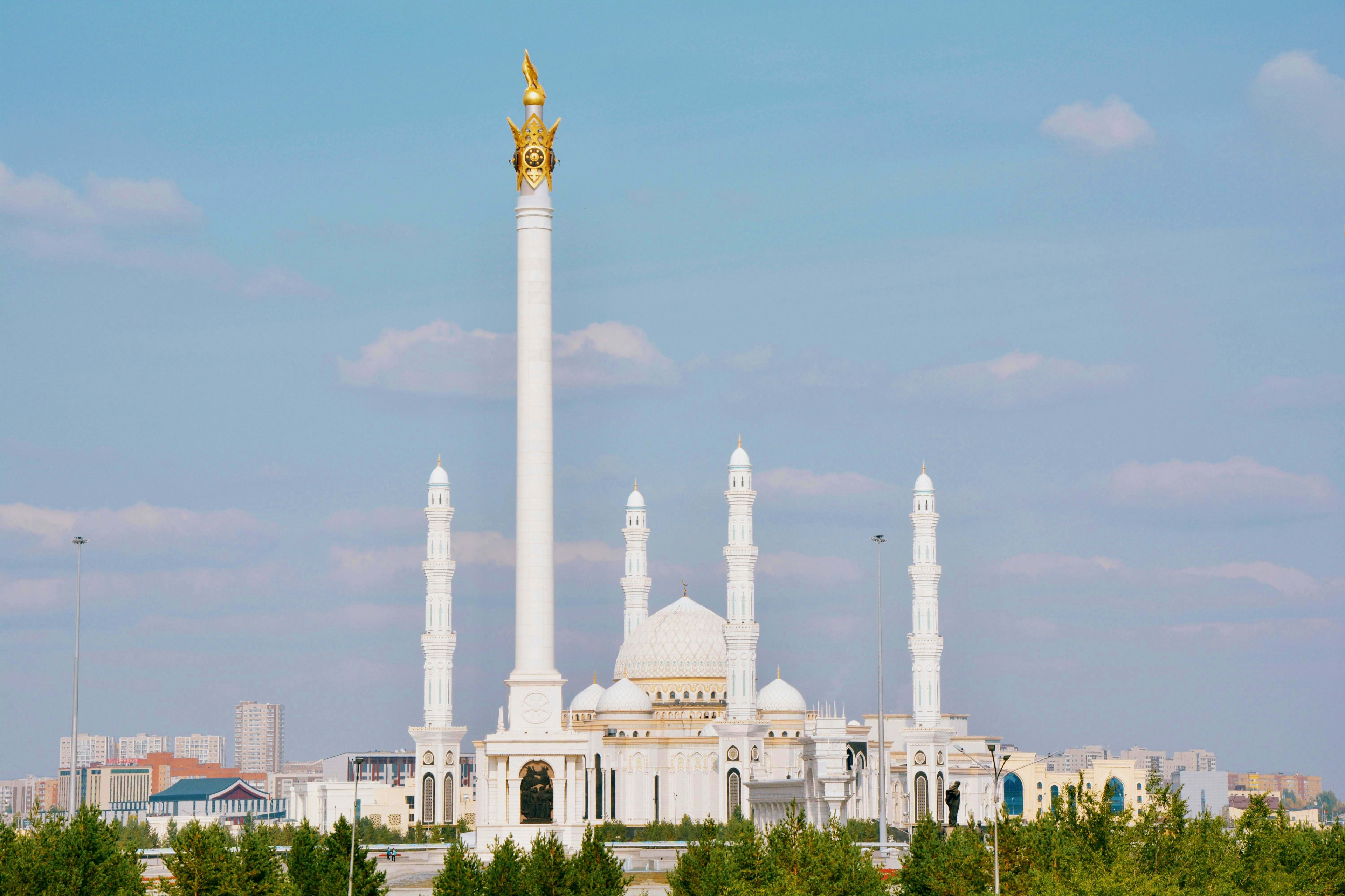 Kazakhstan Hazrat Sultan Mosque in Astana, Kazakhstan with white marble architecture and golden spire against blue sky
