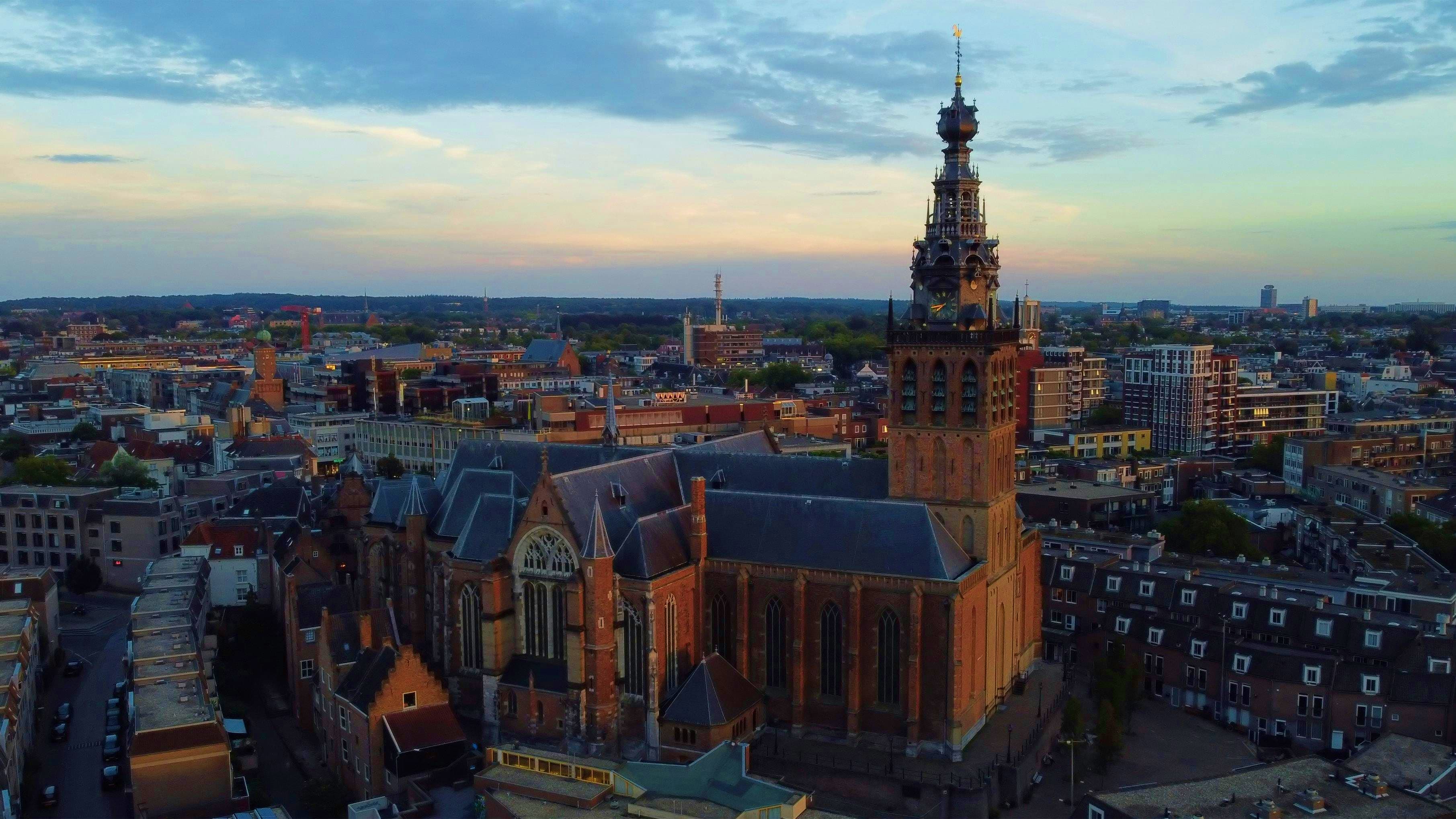 Netherlands Aerial view of Groningen city center with historic red brick church and tower at sunset, Netherlands