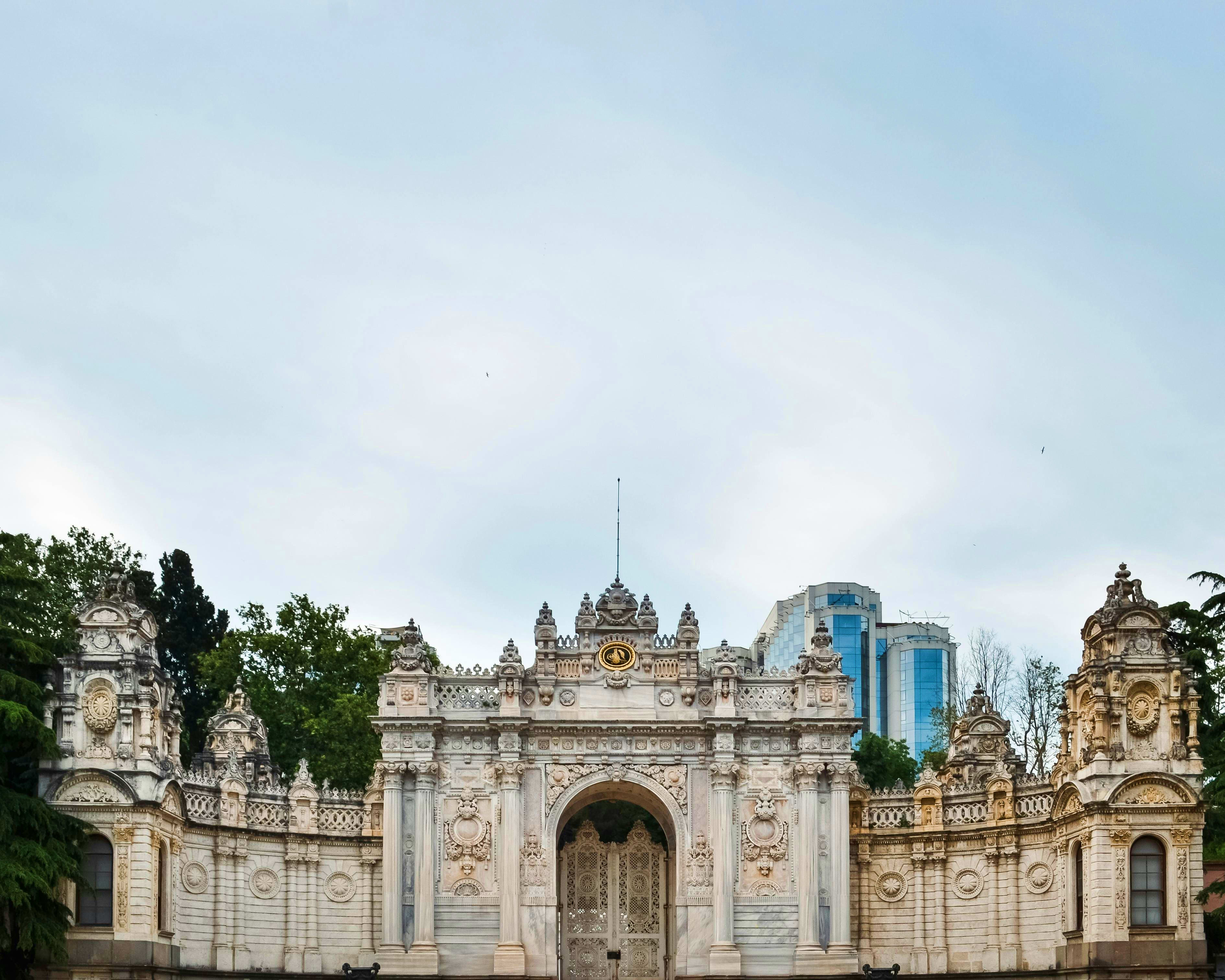 Turkey Ornate white stone palace gate with detailed architectural carvings and turrets, Dolmabahce Palace in Istanbul, Turkey