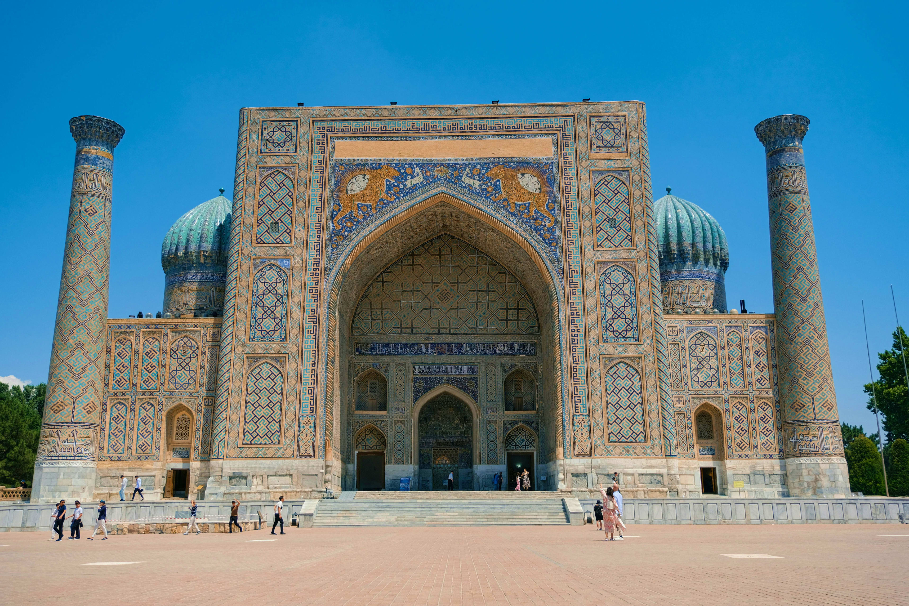 Uzbekistan Registan square in Samarkand, Uzbekistan, featuring ornate tilework and towering minarets against blue sky