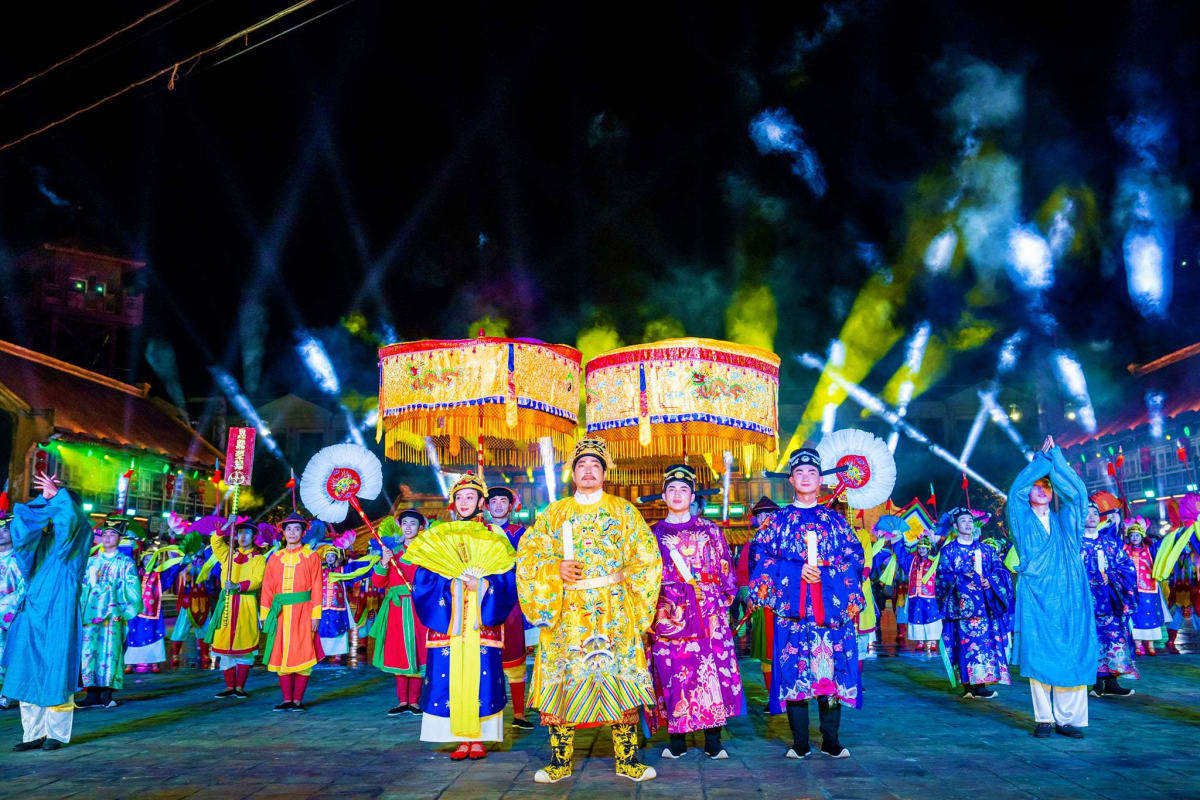 Grand World with Gondola Ride Performers in colorful traditional Vietnamese áo dài costumes at Grand World night festival with illuminated lantern structur