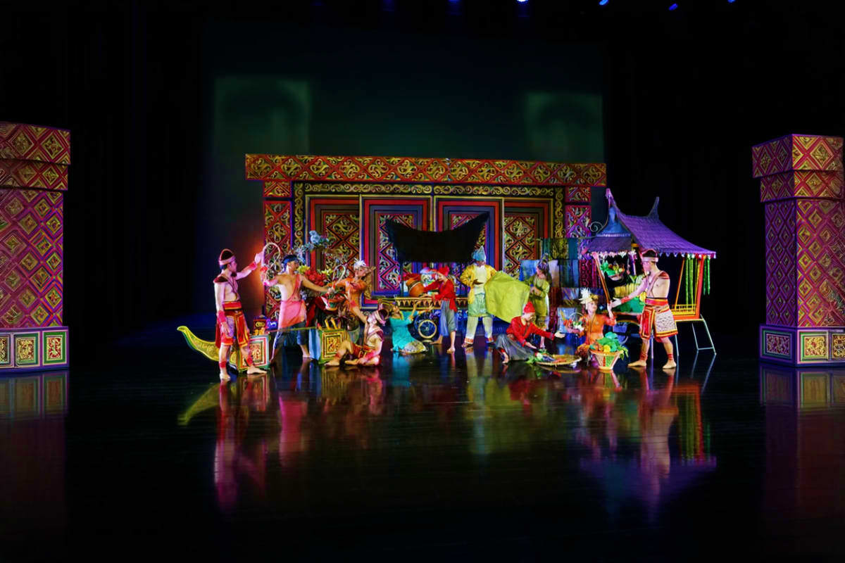 Devdan Show Colorful Southeast Asian theater performance with performers in traditional costumes on an ornate stage set with decorative w