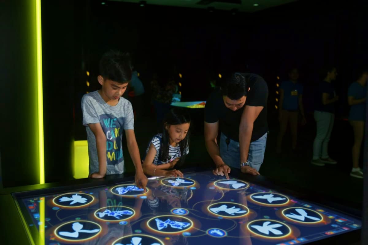 PlayLab Robinsons Galleria in Cebu Children interacting with an illuminated touch-sensitive floor display at PlayLab interactive exhibit