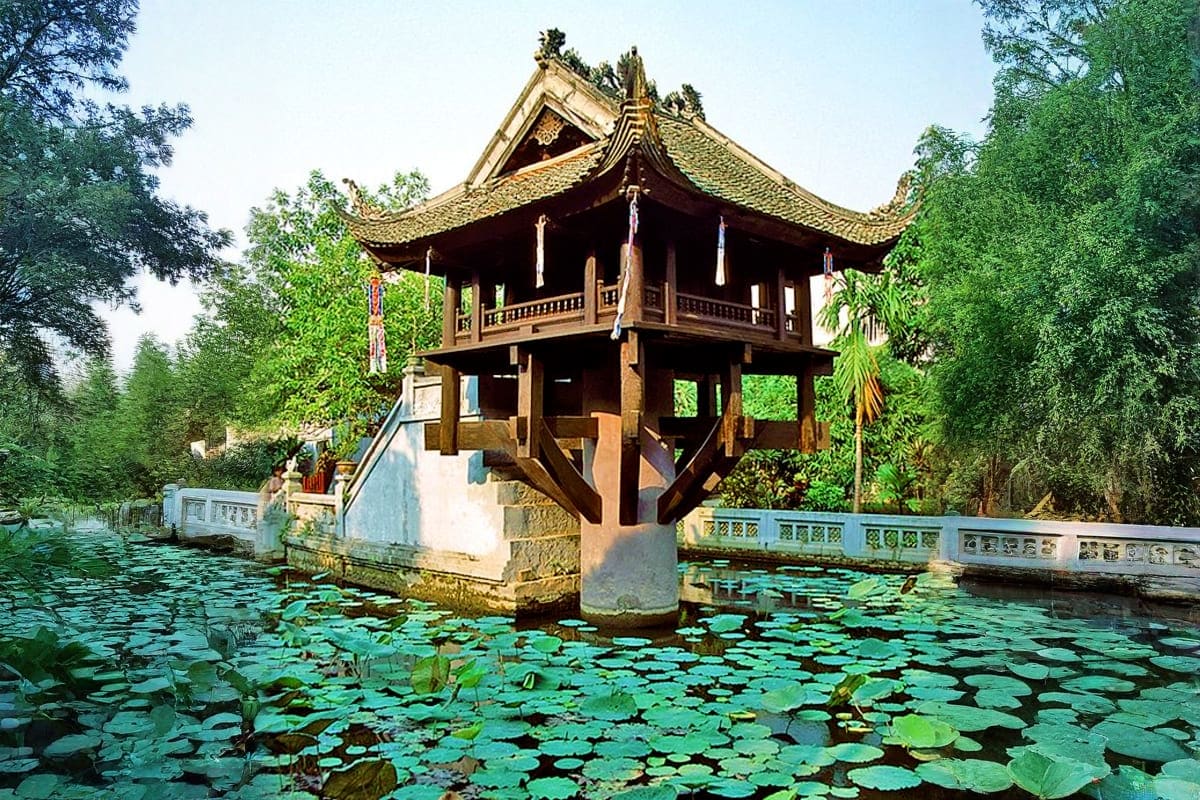 Hanoi Full Day Tour One Pillar Pagoda in Hanoi surrounded by lily pads in a pond, with traditional Vietnamese architecture and curved golden roof