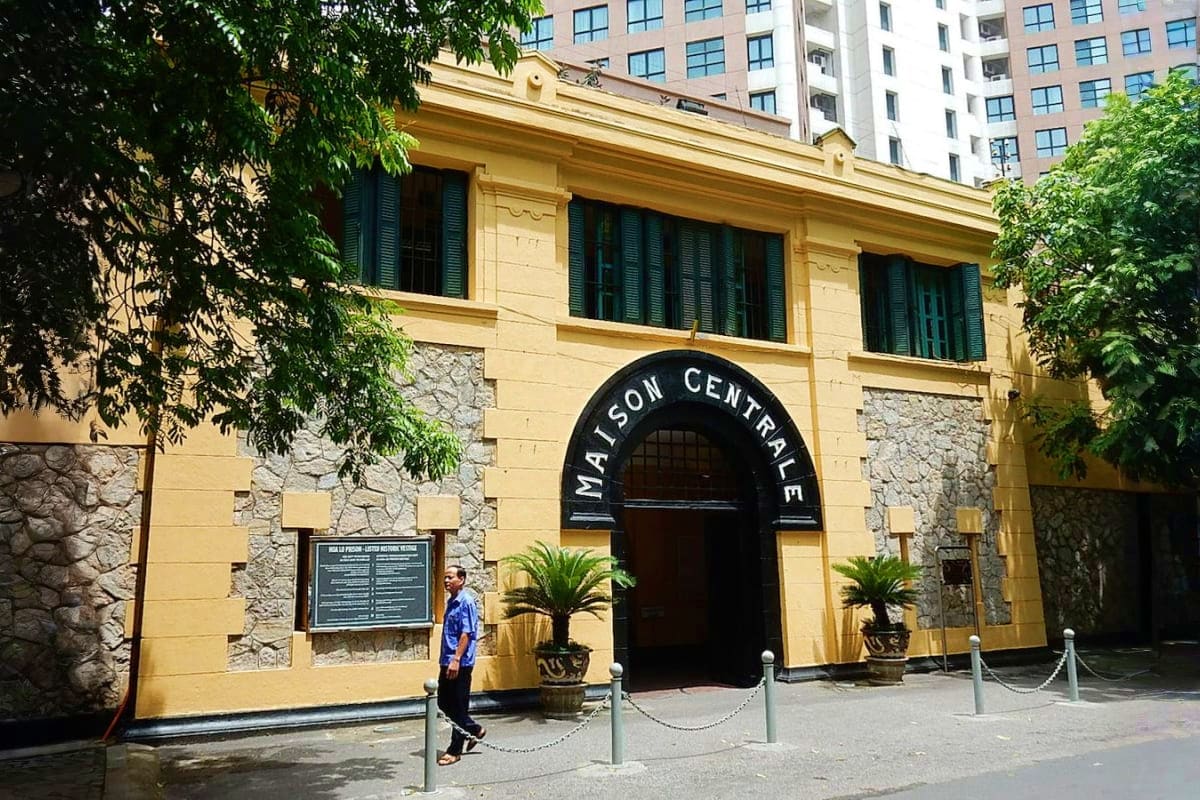 Hanoi Full Day Tour Historic Maison Centrale colonial building facade with yellow walls and arched entrance in Hanoi